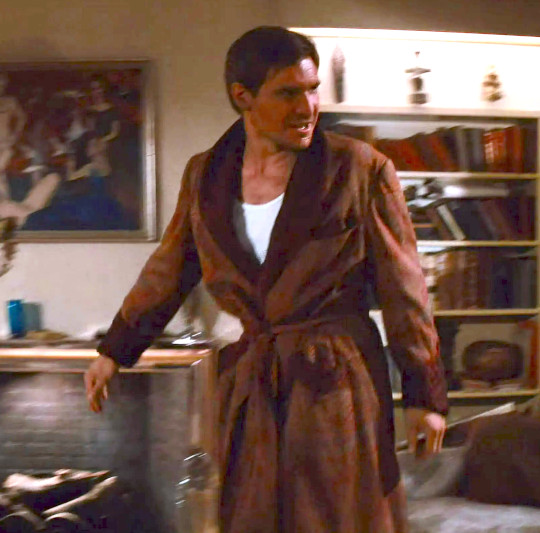 Harrison Ford as Indiana Jones in a dressing gown, receiving Marcus in Raiders of the Lost Ark