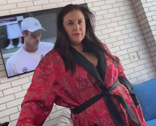 Laura trying on the robe with a serious model pose